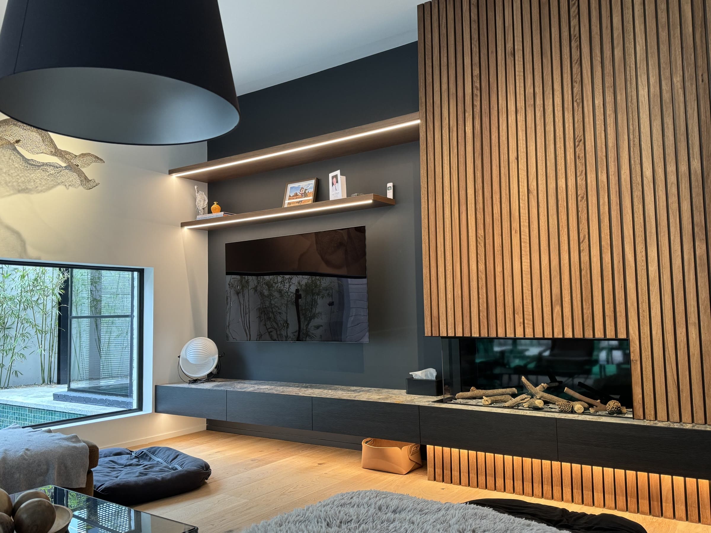 Feature timber slat wall and fireplace joinery